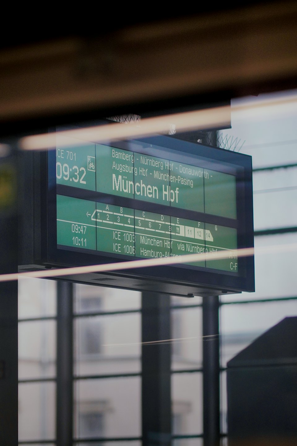 Digital train schedule board displaying destinations and times.
